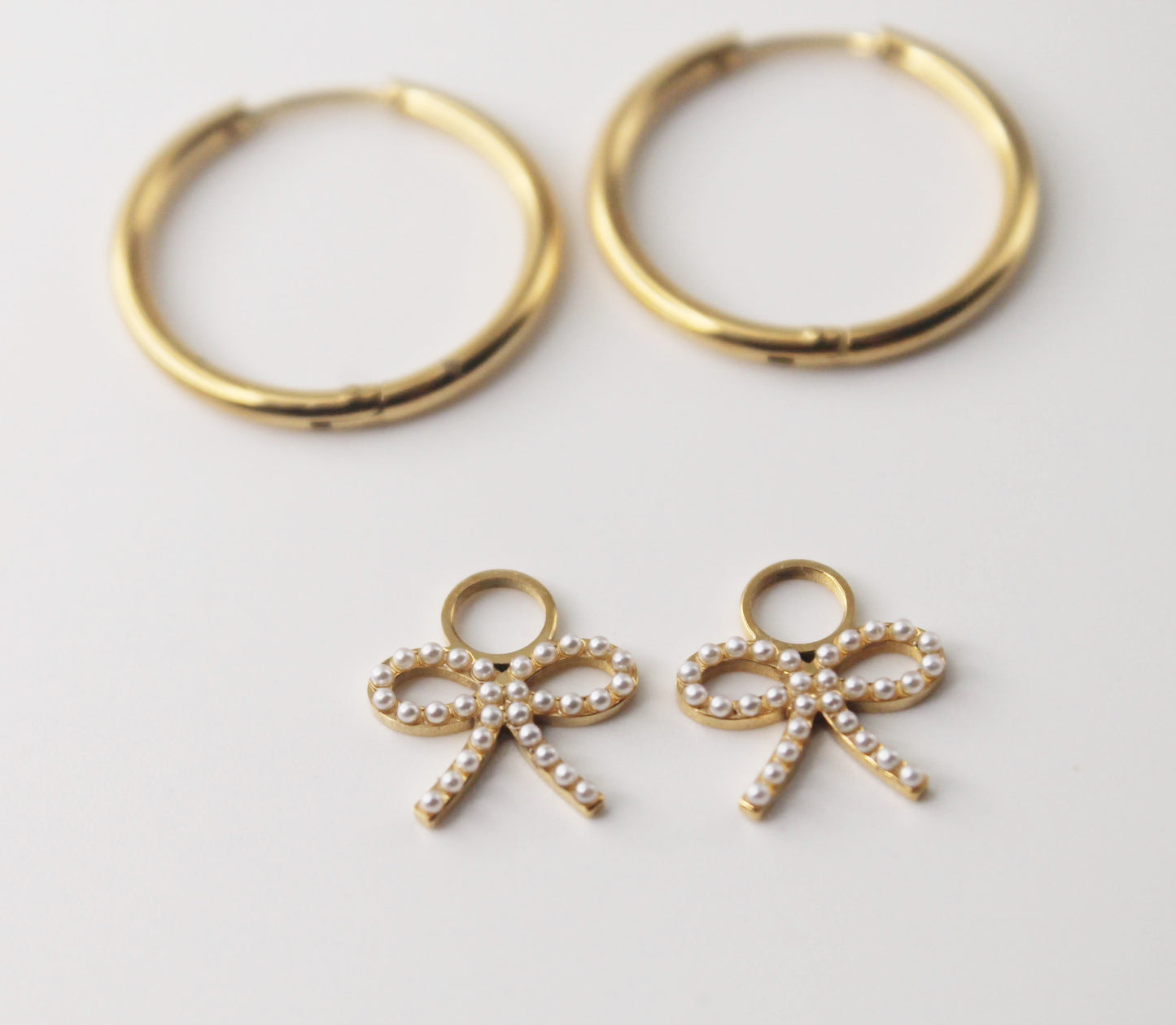 gold hoops with pearl bow charm