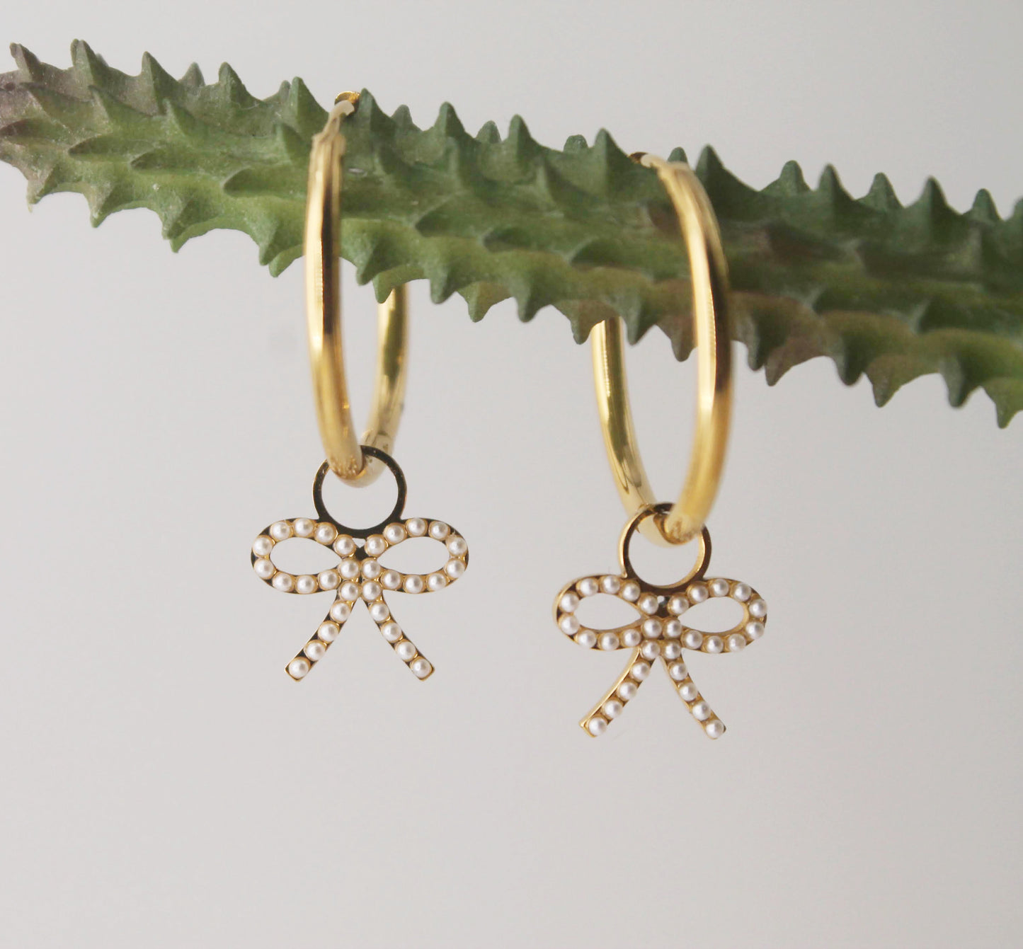gold hoops with pearl bow charm