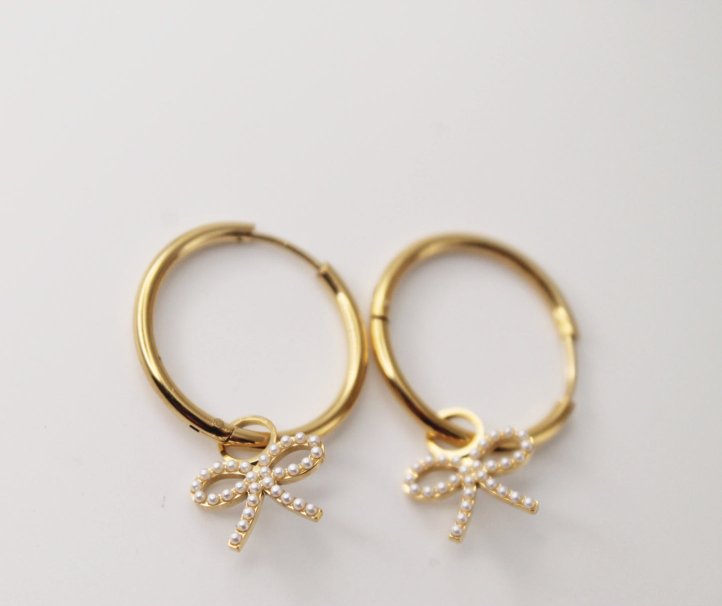 gold hoops with pearl bow charm