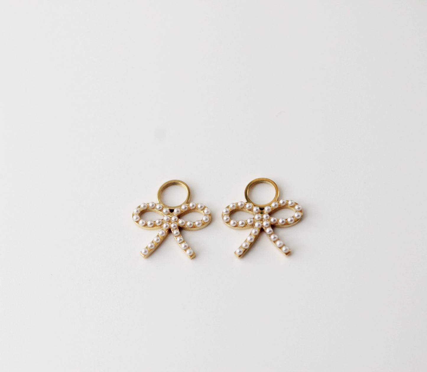 gold hoops with pearl bow charm