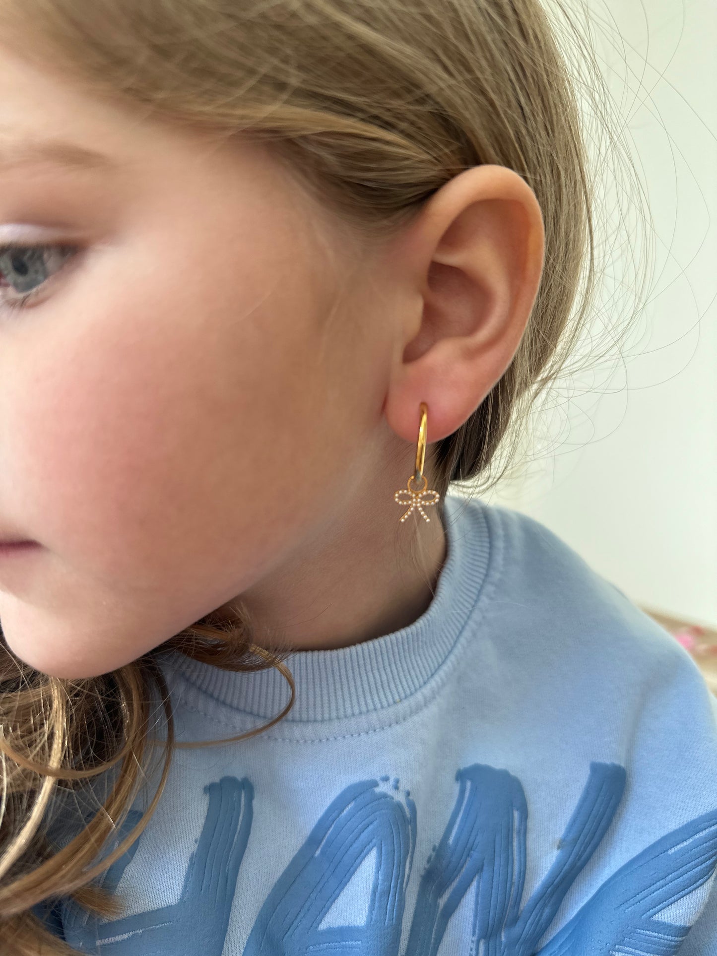 gold hoops with pearl bow charm